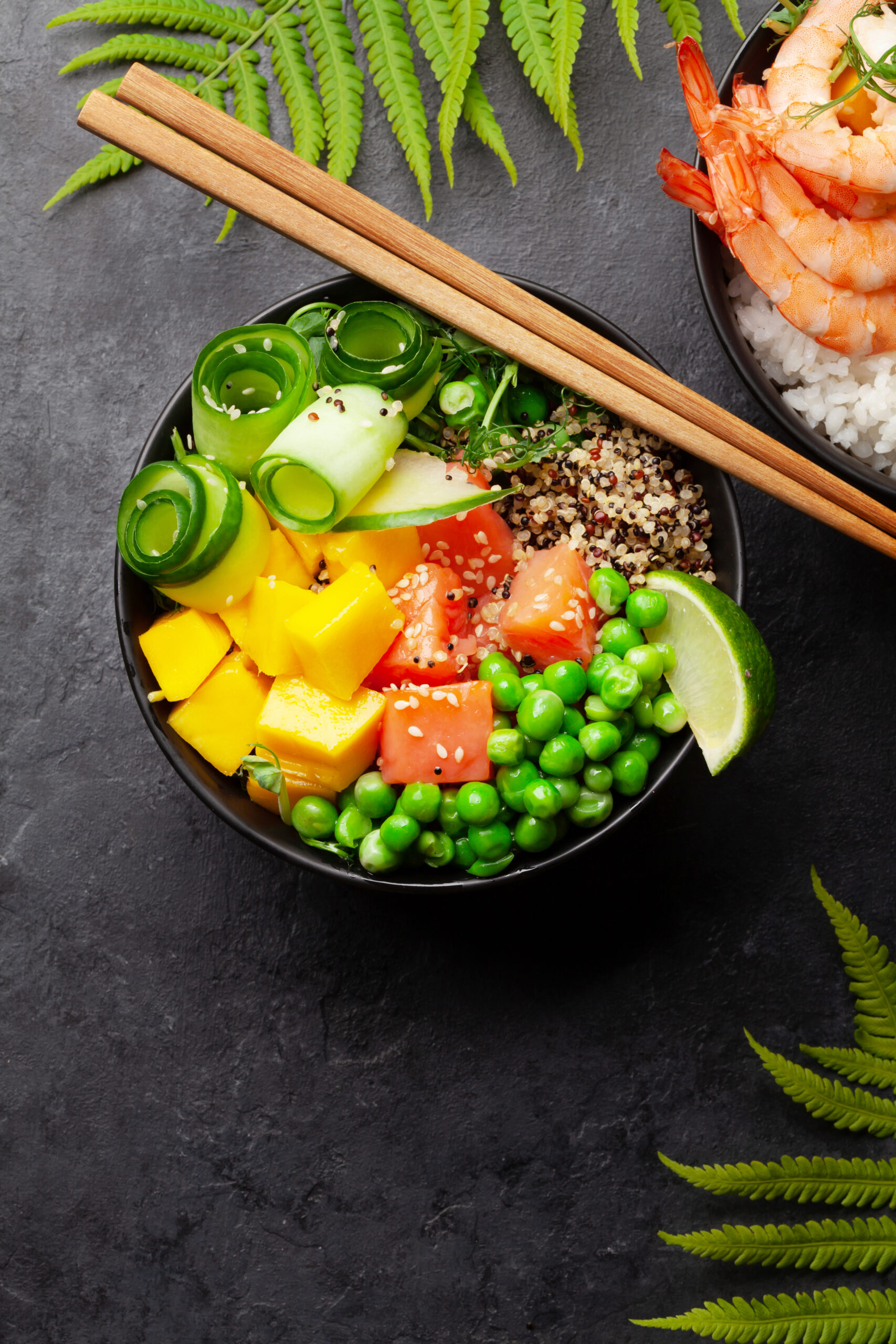 Poke bowls with shrimps, salmon, avocado and mango