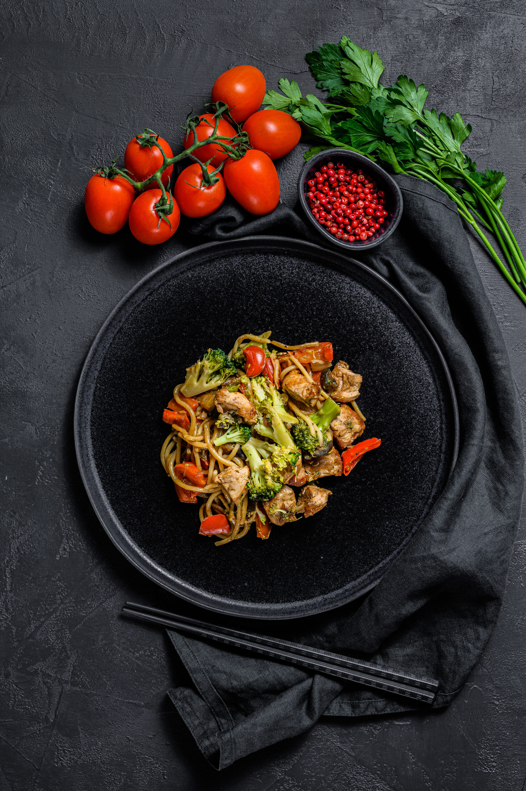 Stir fry noodles, traditional Chinese wok. chopsticks, ingredien